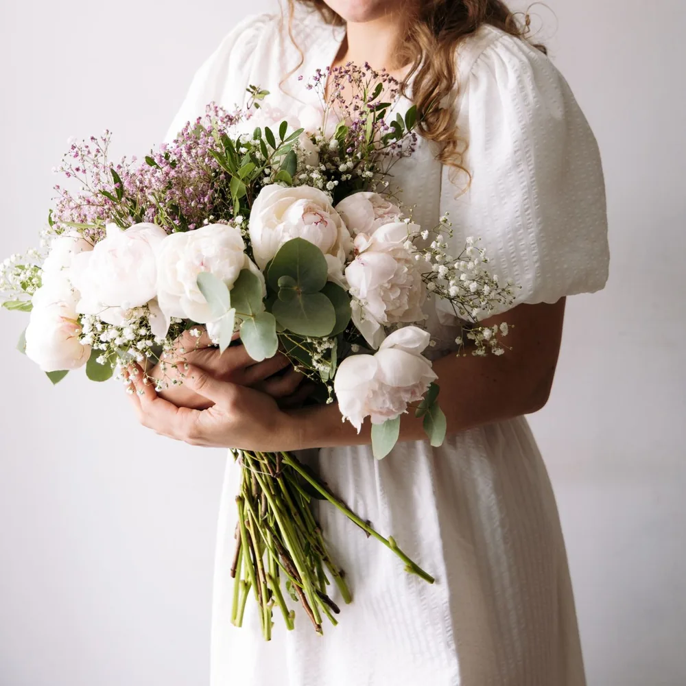 June, the florist, holding a bouquet