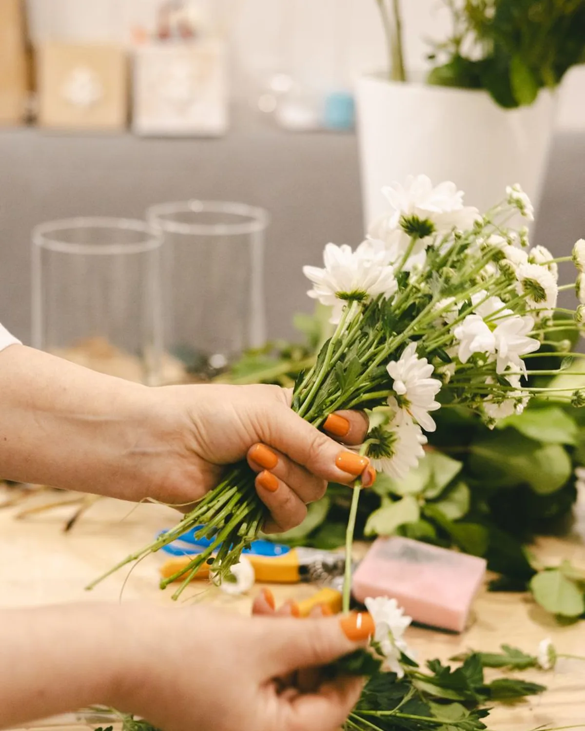 A florist tying a bouquet at the Petal & Stem bench