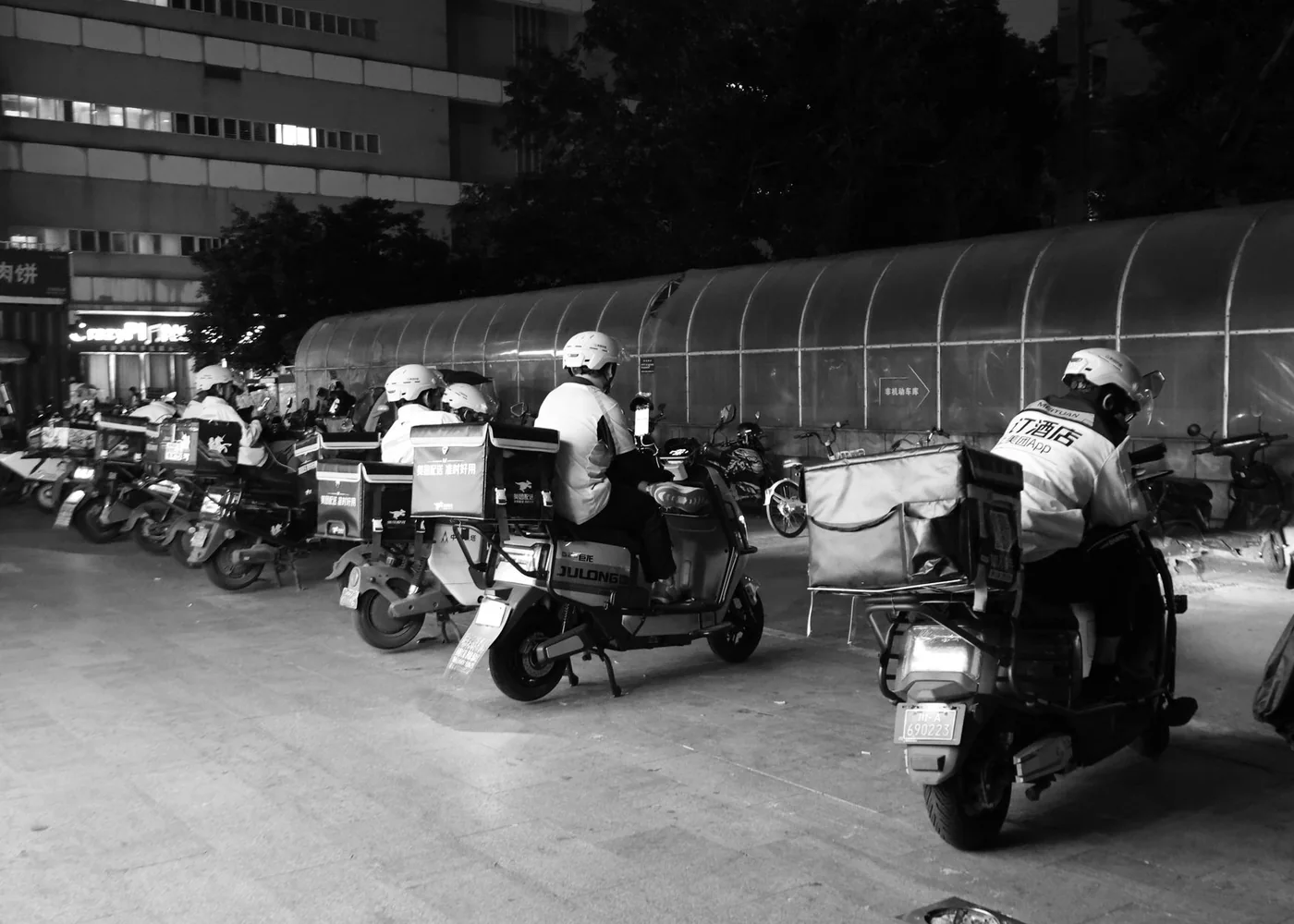 Delivery riders setting out with insulated bags