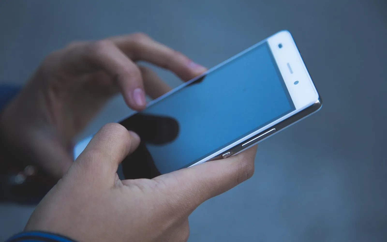 The Domio app on a phone in a lit living room