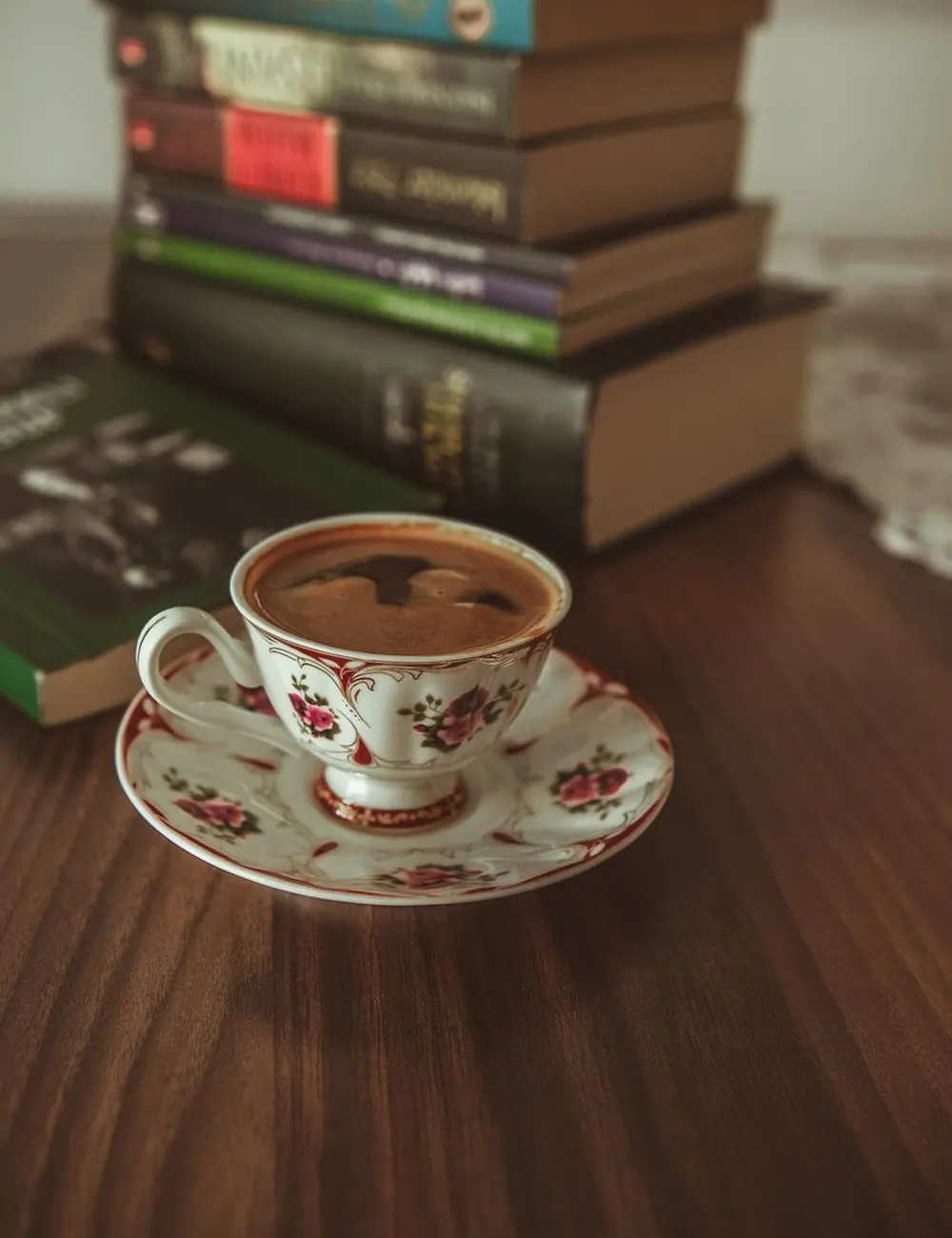 A cup of tea beside an open book