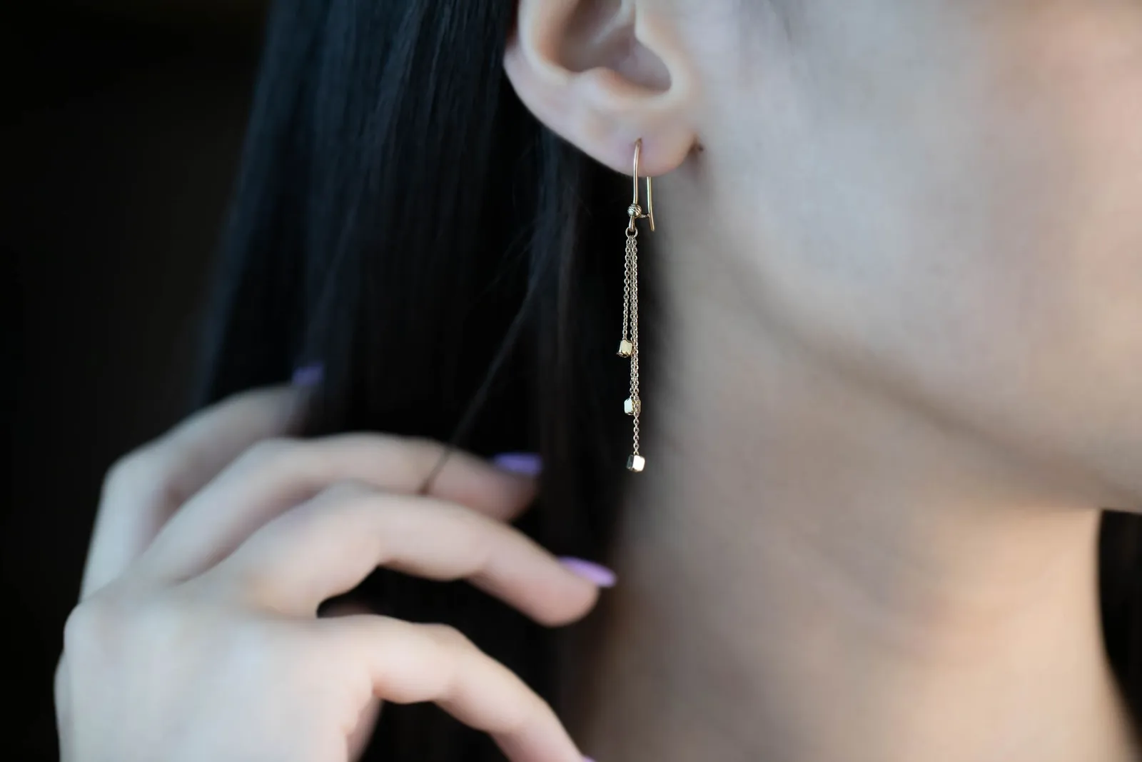 Piercer fitting titanium jewellery in a client's ear